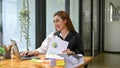 Smiling businesswoman working on her financial work on laptop Royalty Free Stock Photo