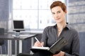 Smiling businesswoman writing notes Royalty Free Stock Photo