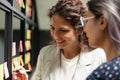 Smiling businesswoman writing notes on sticky papers on glass wall Royalty Free Stock Photo