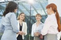 Smiling businesswomen conversing in office