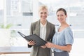 Smiling businesswomen looking at camera and working together Royalty Free Stock Photo