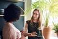 Smiling businesswomen talking together during a break in an office Royalty Free Stock Photo