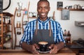 Smiling cafe barista holding a fresh cup of cappuccino Royalty Free Stock Photo