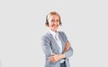 Happy call centre operator with headset crossing arms on light background Royalty Free Stock Photo