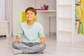 Calm positive boy sit in his room on the floor Royalty Free Stock Photo