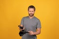 smiling cameraman vlogging with film set. unshaven man with camcorder. videographer making video Royalty Free Stock Photo