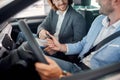 Smiling car dealer selling car to young man Royalty Free Stock Photo