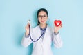 Smiling cardiologist woman carrying stethoscope