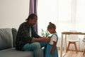 Black father correcting jeans dress of daughter Royalty Free Stock Photo