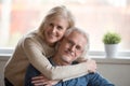 Smiling caring middle aged wife embracing senior husband, portra Royalty Free Stock Photo