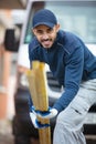smiling carpenter holding wood planks in construction site Royalty Free Stock Photo
