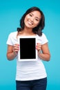 Smiling casual asian woman showing blank tablet computer screen Royalty Free Stock Photo