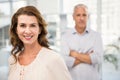 Smiling casual businesswoman in front of her colleague Royalty Free Stock Photo