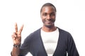 Smiling casual dressed black man showing peace sign.