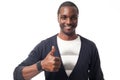 Smiling casual dressed black man with thumbs up.