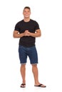 Smiling Casual Man In Jeans Shorts And Black Shirt