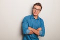 Smiling casual man wearing glasses standing with hands crossed Royalty Free Stock Photo