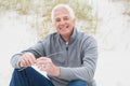 Smiling casual senior man relaxing at beach Royalty Free Stock Photo