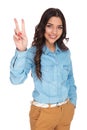 Smiling casual woman making the victory sign Royalty Free Stock Photo