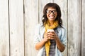 Smiling casual woman posing with glasses while holding coffee Royalty Free Stock Photo