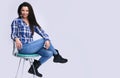 Smiling casual woman sitting on a chair. Isolated Royalty Free Stock Photo