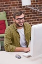 Smiling casual young man using computer Royalty Free Stock Photo