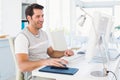 Smiling casual young man using computer Royalty Free Stock Photo