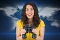 Smiling casual young woman holding binoculars