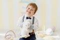 Smiling Caucasian Boy Playing with Easter Rabbit