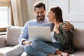 Smiling Caucasian couple have fun using laptop Royalty Free Stock Photo