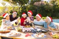 Smiling caucasian family spending time together and having christmas tree in the garden Royalty Free Stock Photo