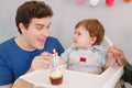 Smiling Caucasian father with baby boy celebrating his first birthday at home. Proud parent dad together with a child kid toddler Royalty Free Stock Photo