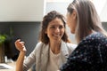 Smiling caucasian female manager communicating with asian colleague. Royalty Free Stock Photo