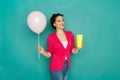Happy caucasian girl with coffee and balloon at studio background