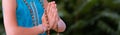 Smiling caucasian girl in namaste. girl hands close up with rosary in namaste gesture outdoor summer day. yoga, mindfulness,