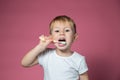 Smiling caucasian little boy cleaning his teeth with manual children toothbrush