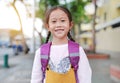 Smiling caucasian little girl walking on walkway go to school. Little schoolgirl with a backpack. Back to school concept Royalty Free Stock Photo