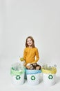 Smiling girl with plastic bottle sorting garbage Royalty Free Stock Photo