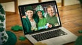 Smiling caucasian male friends making st patrick\'s day video call embracing on laptop screen