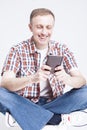 Smiling Caucasian Man in Checkered Shirt and Jeans Chatting on Cellphone Against White Royalty Free Stock Photo