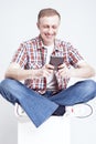 Smiling Caucasian Man in Checkered Shirt and Jeans Chatting on Cellphone Royalty Free Stock Photo