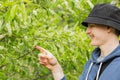 Smiling caucasian man looking at the may beetle melolontha on his forefinger. Maybug is crawling on a man& x27;s finger.