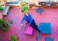 Smiling Caucasian man relaxing on red terracotta Italian patio Royalty Free Stock Photo