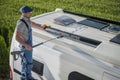 Smiling Caucasian Men Washing His Motorhome RV Camper Van