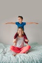 Smiling Caucasian mother and boy son playing in bedroom at home. Child sitting on moms shoulders and laughing. Family having fun Royalty Free Stock Photo