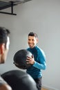 Smiling personal trainer with medicine ball in a fitness class Royalty Free Stock Photo