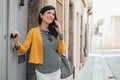 Smiling caucasian pregnant woman using mobile in the streets of an old town Royalty Free Stock Photo