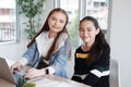 Smiling Caucasian student girls is online learning and make homework for homeschool. They are researching knowledge with internet Royalty Free Stock Photo