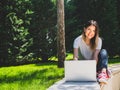 Smiling caucasian woman with laptop outdoors. Distance learning online education Royalty Free Stock Photo