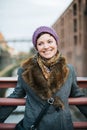 Smiling Caucasian woman looking away standing on a bridge